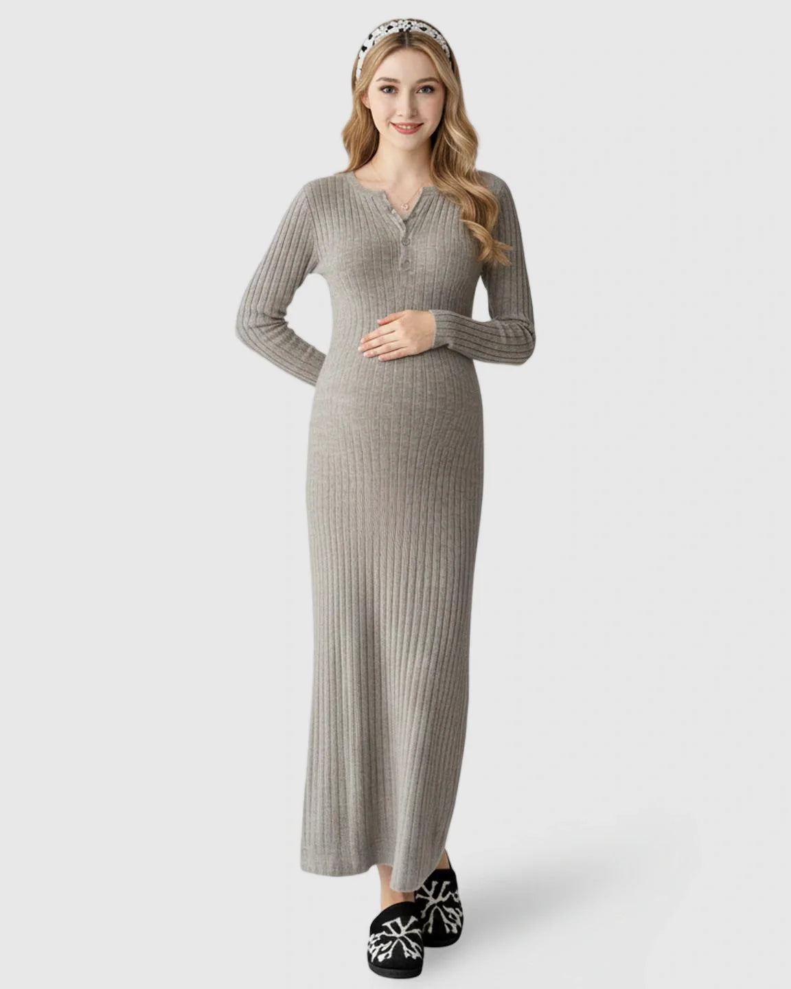 Smiling pregnant woman in a gray ribbed knit A-line long sleeve maternity maxi dress.