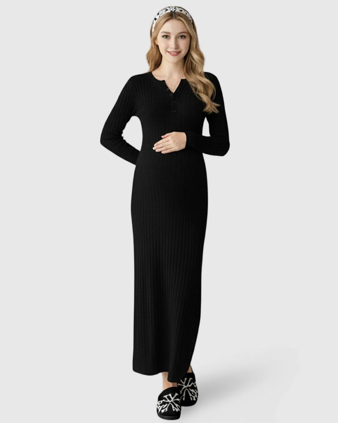 Smiling pregnant woman in a black ribbed knit A-line long sleeve maternity maxi dress with button-front detail.