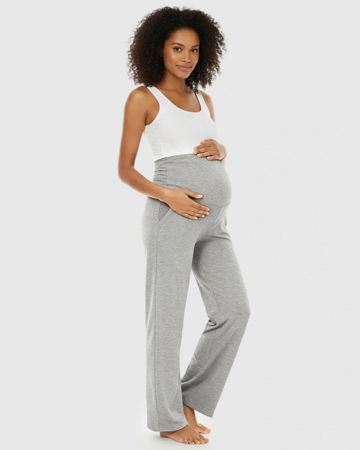 Pregnant woman in gray wide-leg maternity lounge pants with a foldable waistband and side pockets.