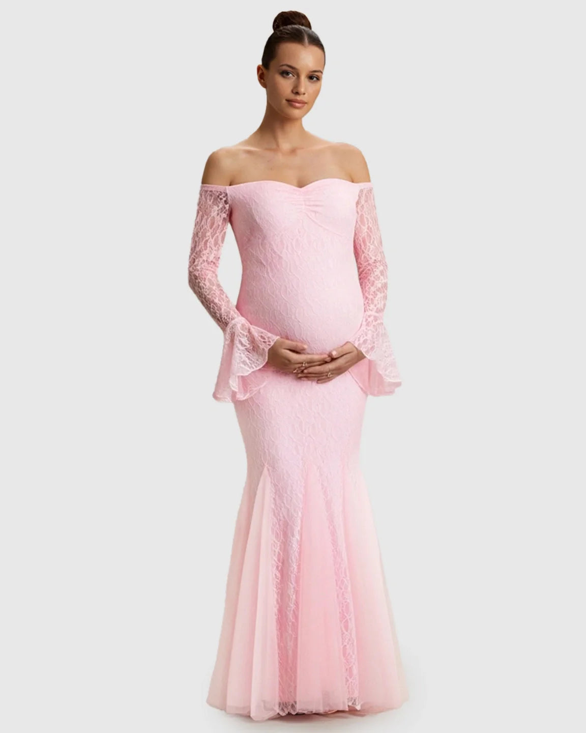Pink lace off-shoulder mermaid maternity maxi dress with long bell sleeves, worn by a pregnant model.