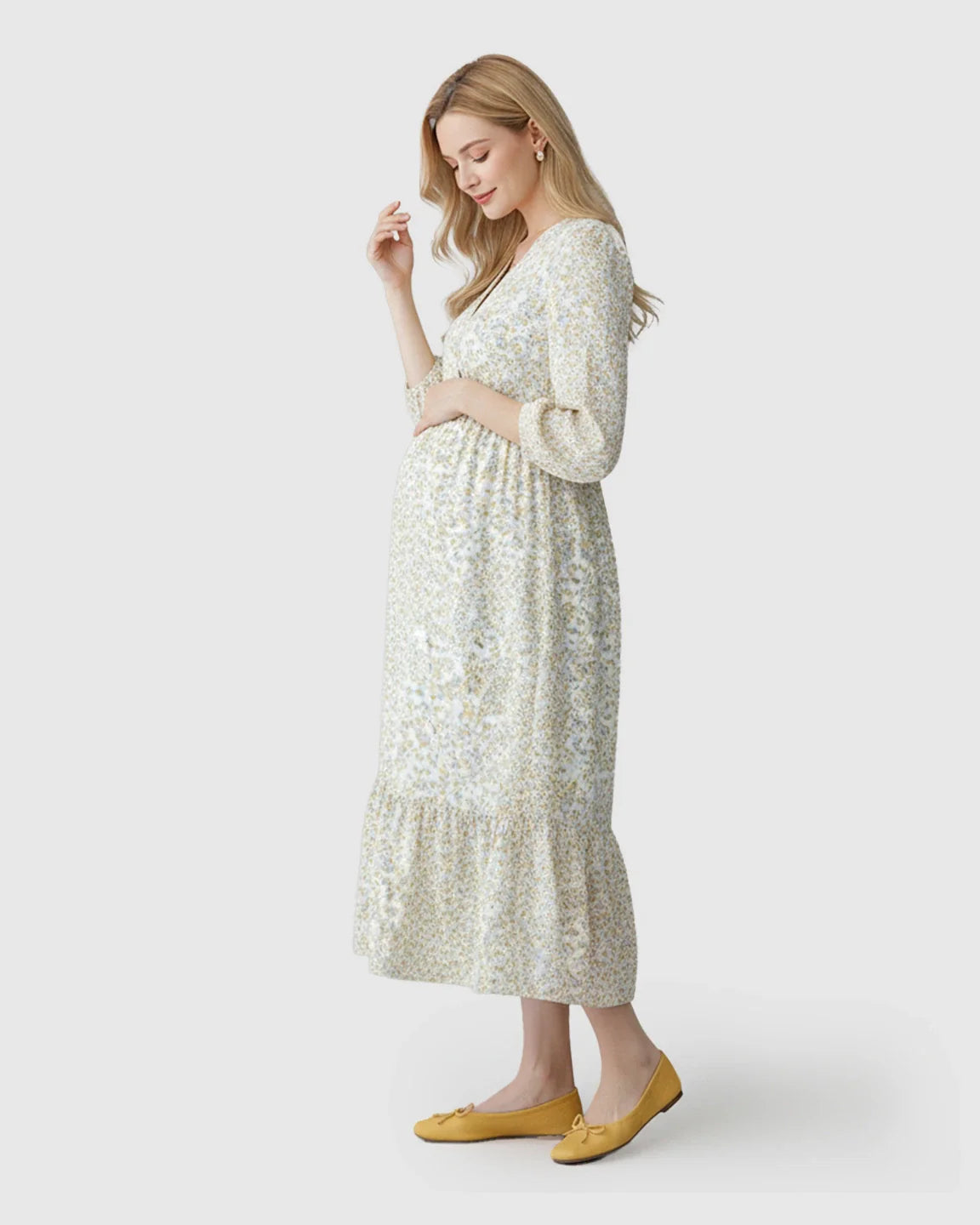 Maternity midi dress in a white floral print with smocked waist, ruffle hem, and 3/4 sleeves.