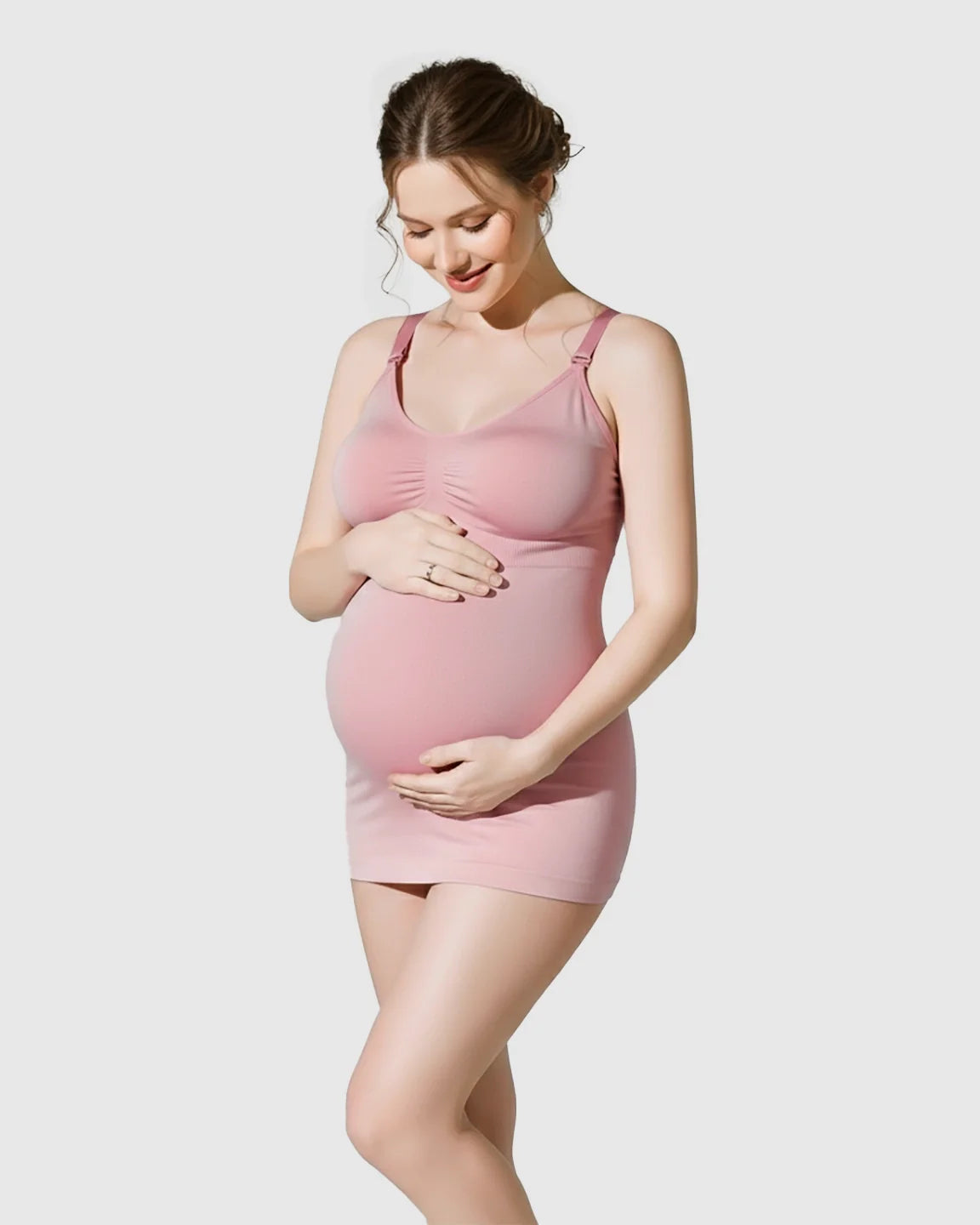 Pregnant woman in a pink soft stretch front-opening wireless maternity nursing bra and matching camisole.