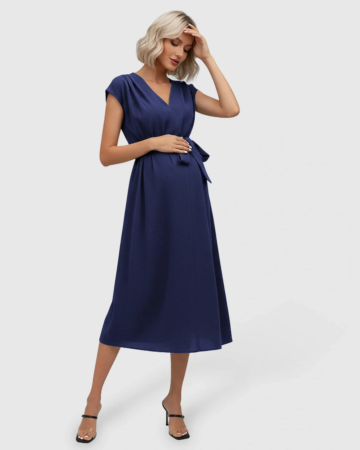 Navy V-neck maternity midi dress with flutter sleeves and adjustable tie-waist, worn by a pregnant model.