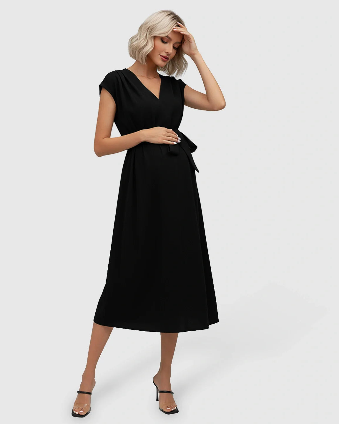 Black V-neck maternity midi dress with flutter sleeves and adjustable tie-waist, worn by a blonde model.