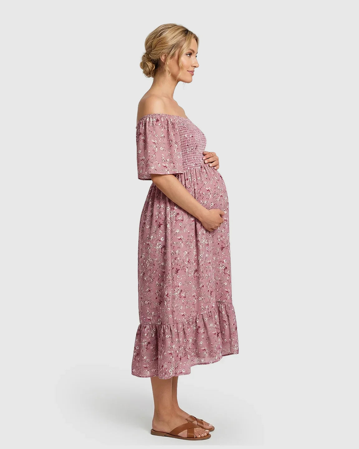 Pink floral off-shoulder smocked maternity midi dress with flutter sleeves and tiered skirt.