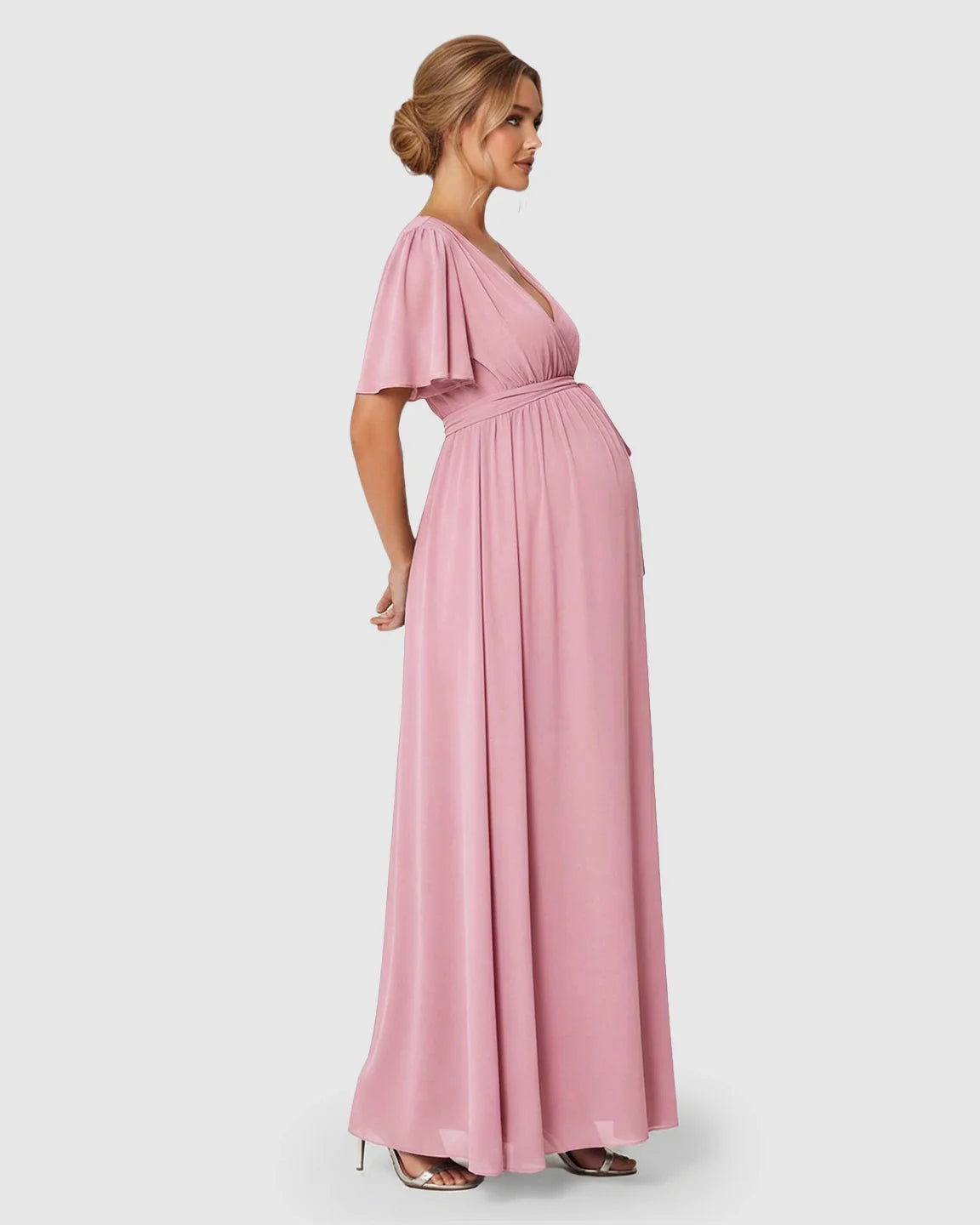 Pink surplice V-neck flutter sleeve maternity maxi dress with empire waist and front slit.