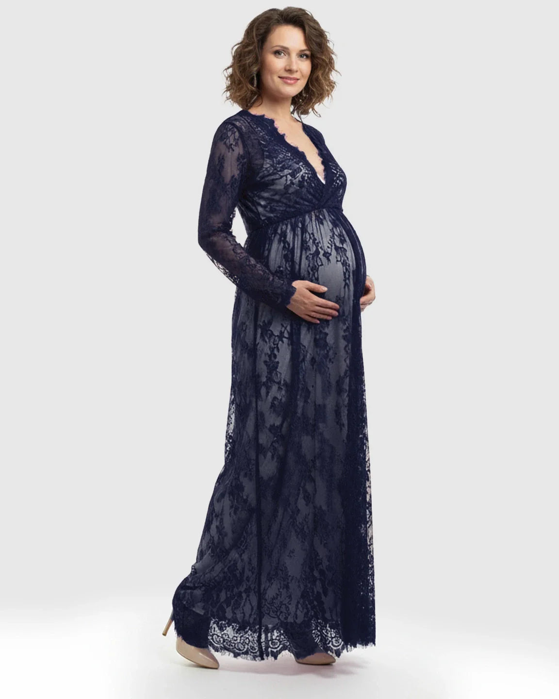 Maternity maxi dress in navy sheer floral lace, featuring an empire waist and V-neck, worn by a smiling pregnant woman.