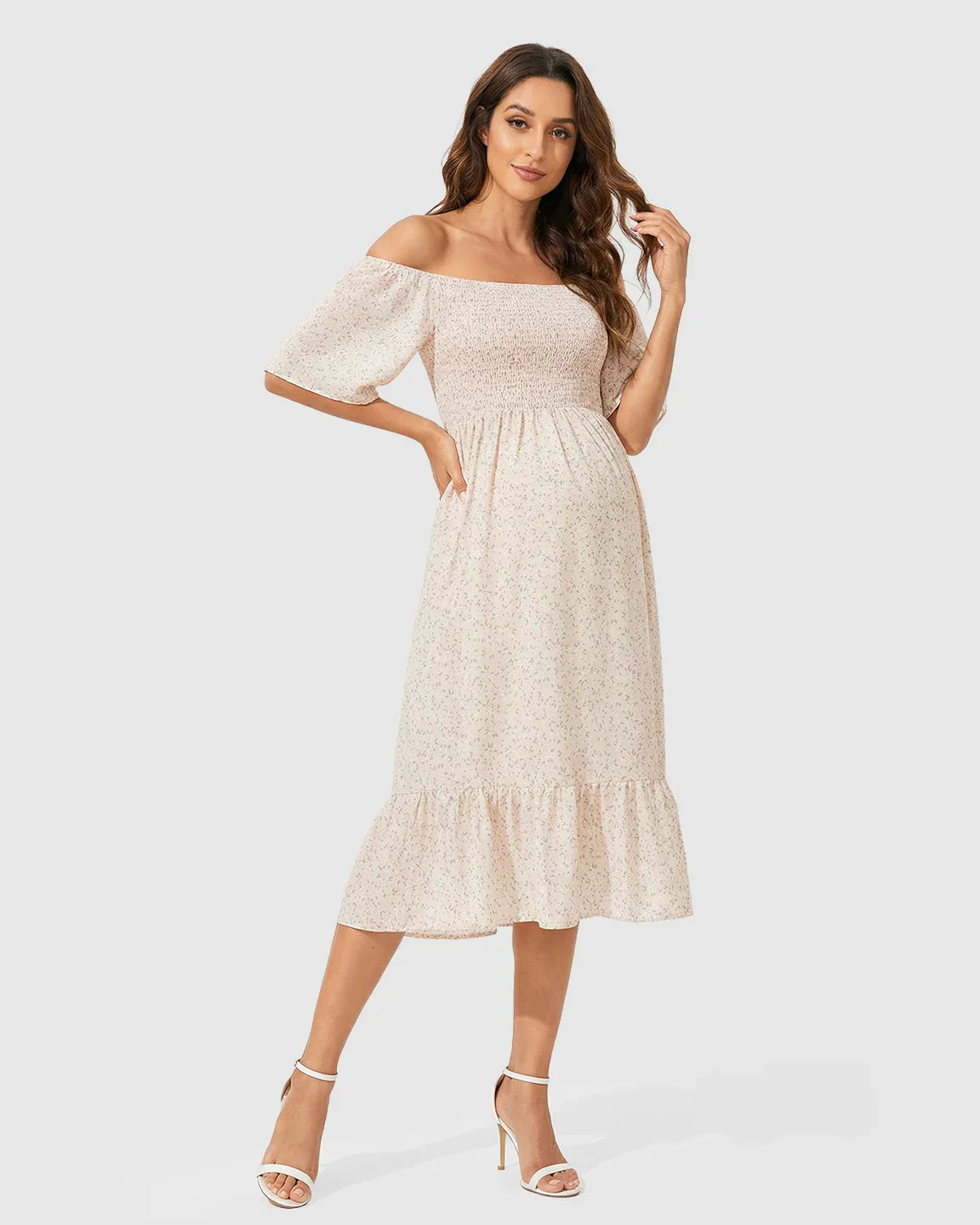 Maternity midi dress with flutter sleeves, smocked top, tiered skirt, and small floral print.