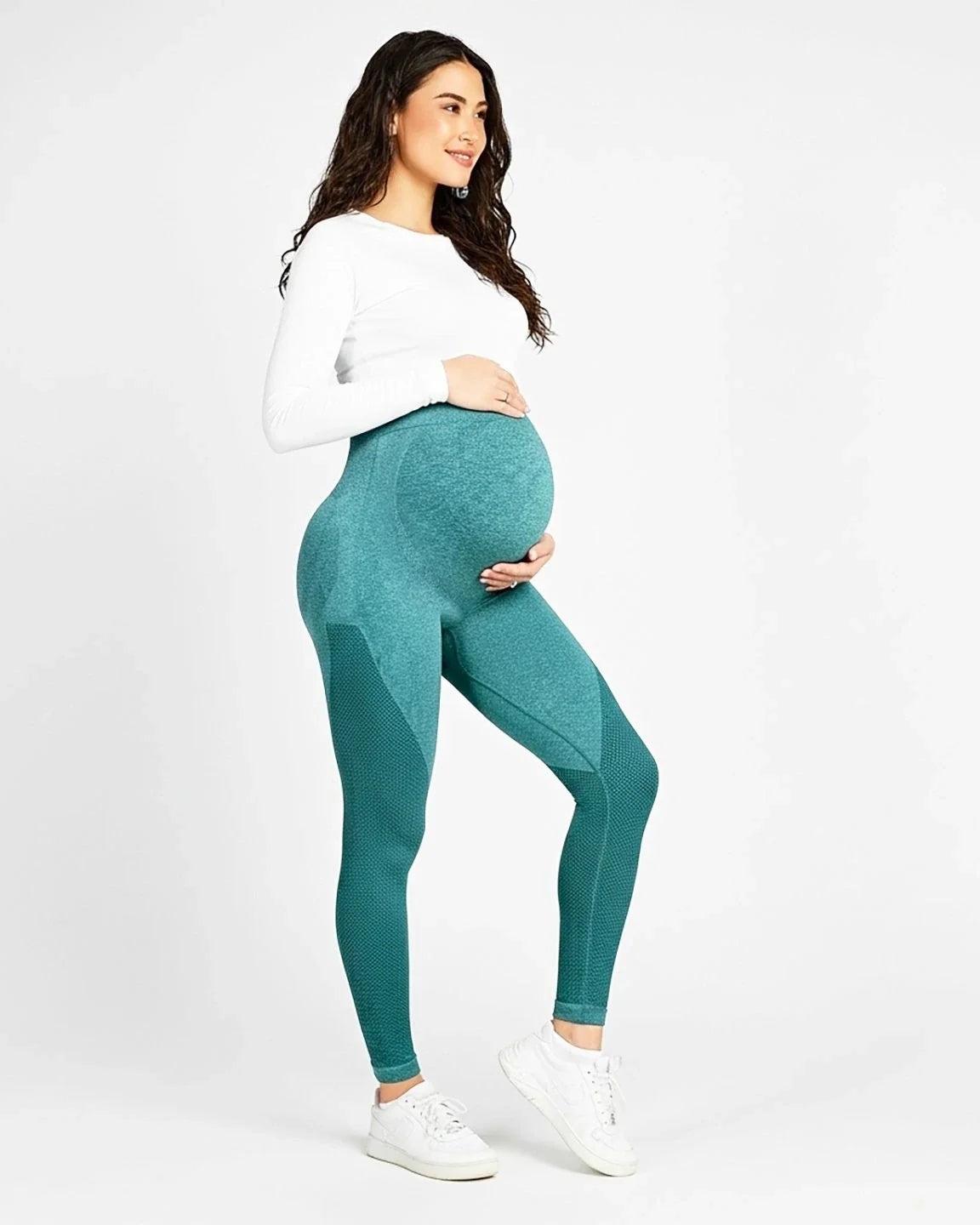 Pregnant woman wearing teal high-elastic, body-hugging maternity leggings with subtle textured details.