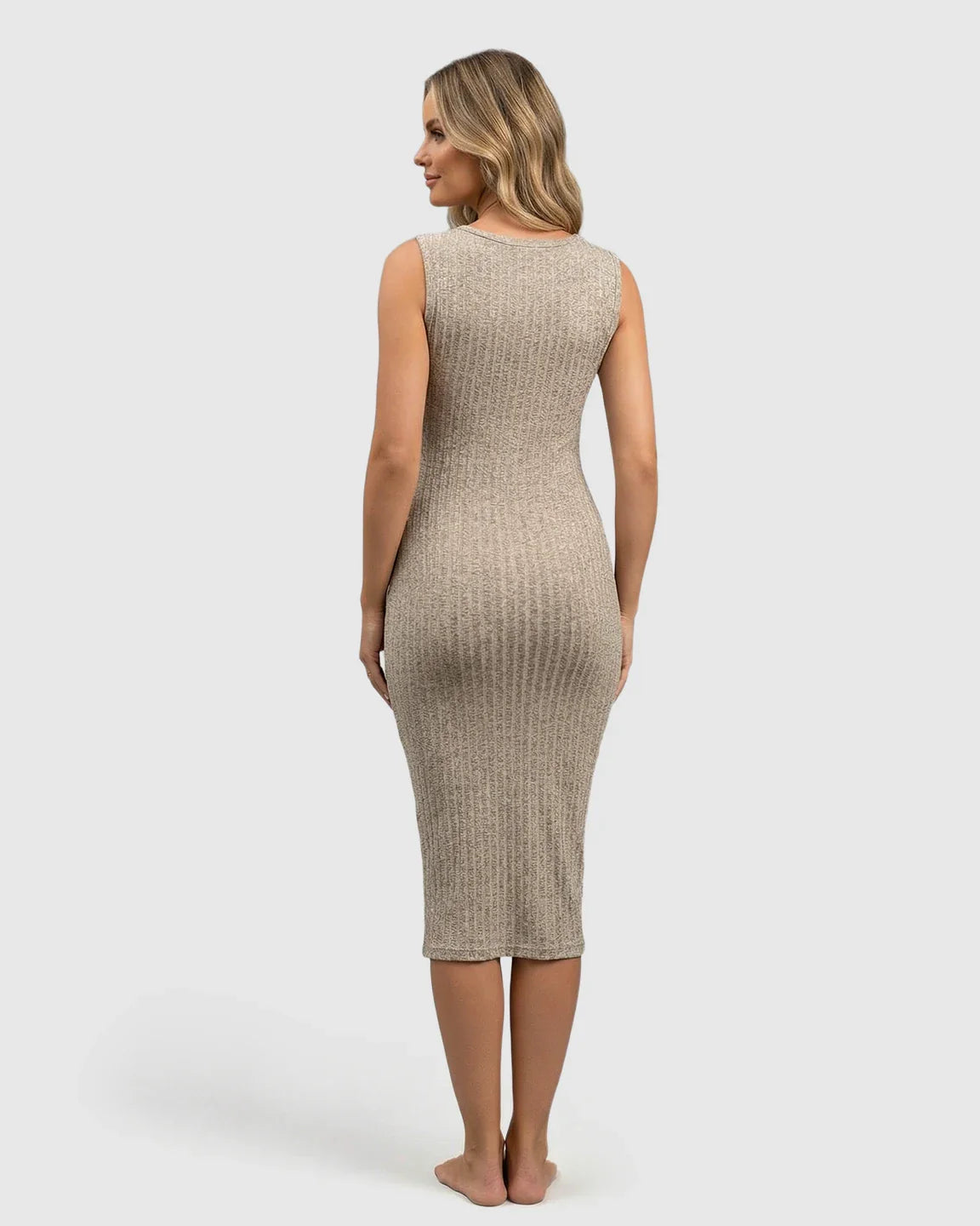 Blonde woman in a beige ribbed bodycon maternity & nursing midi dress, back view.