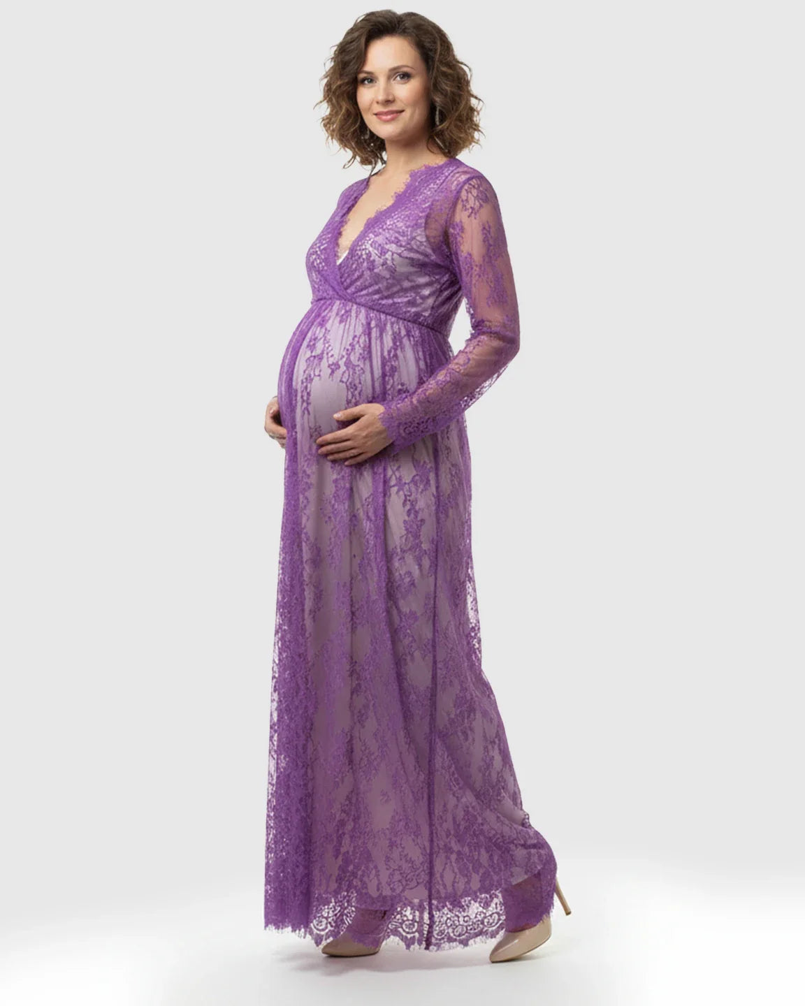 Pregnant woman in a sheer floral lace empire waist maternity maxi dress in lavender.