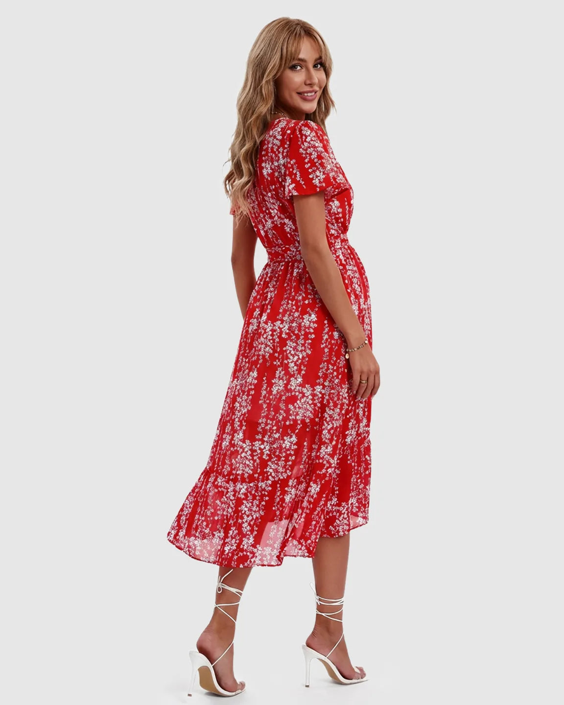 Red floral V-neck ruffled hem maternity midi dress with short sleeves, worn by a smiling model.