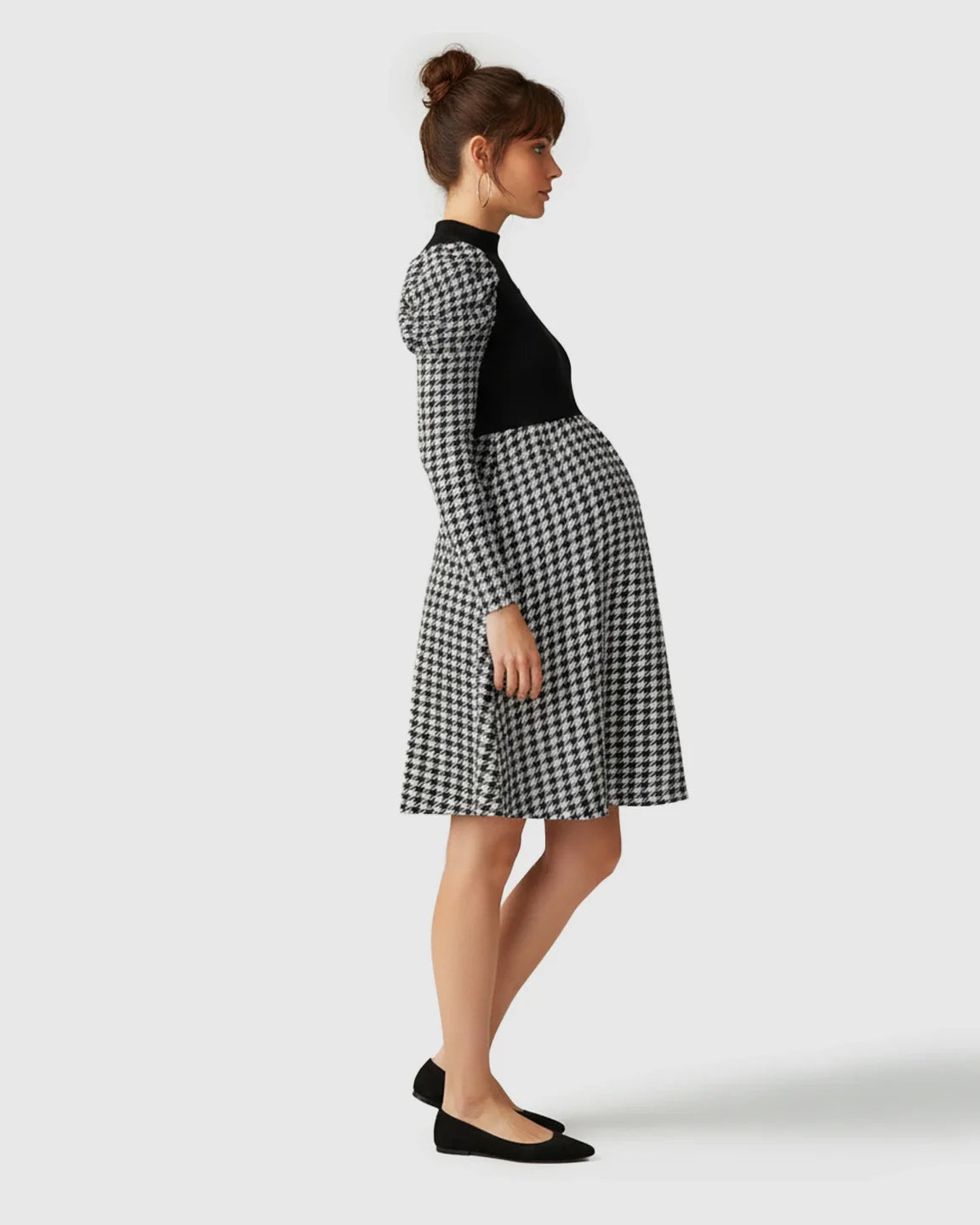 Elegant maternity short dress with black knit bodice, houndstooth skirt, and puff sleeves.