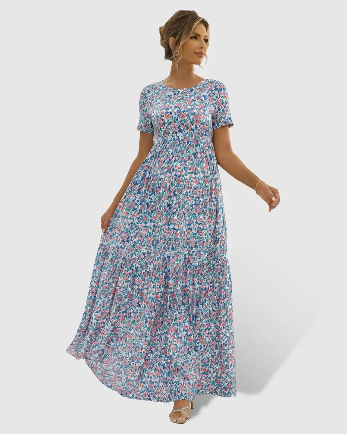 Flowy floral-pastoral maternity maxi dress with round neckline, short sleeves, and chiffon skirt.