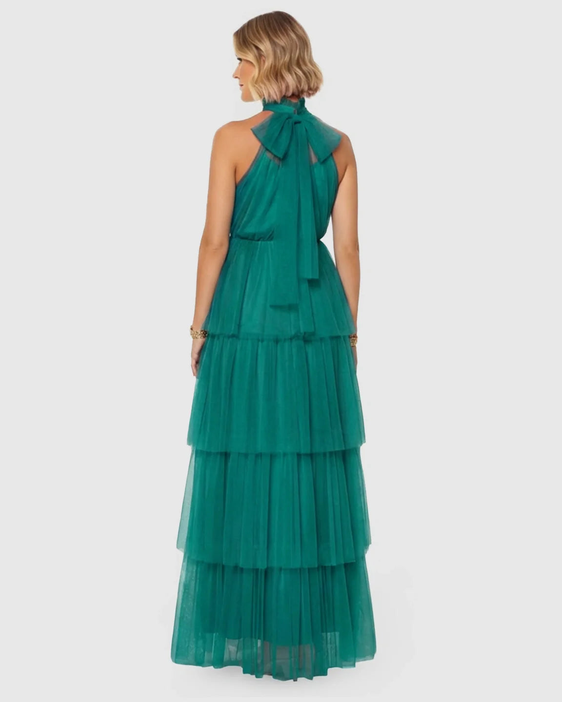 Emerald green halter neck tiered mesh maternity gown with a back bow detail.