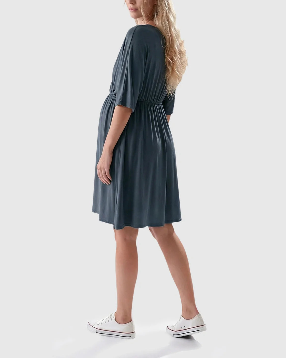 Woman in a dark gray maternity midi dress with a cross-front, 3/4 sleeves, and an A-line silhouette.