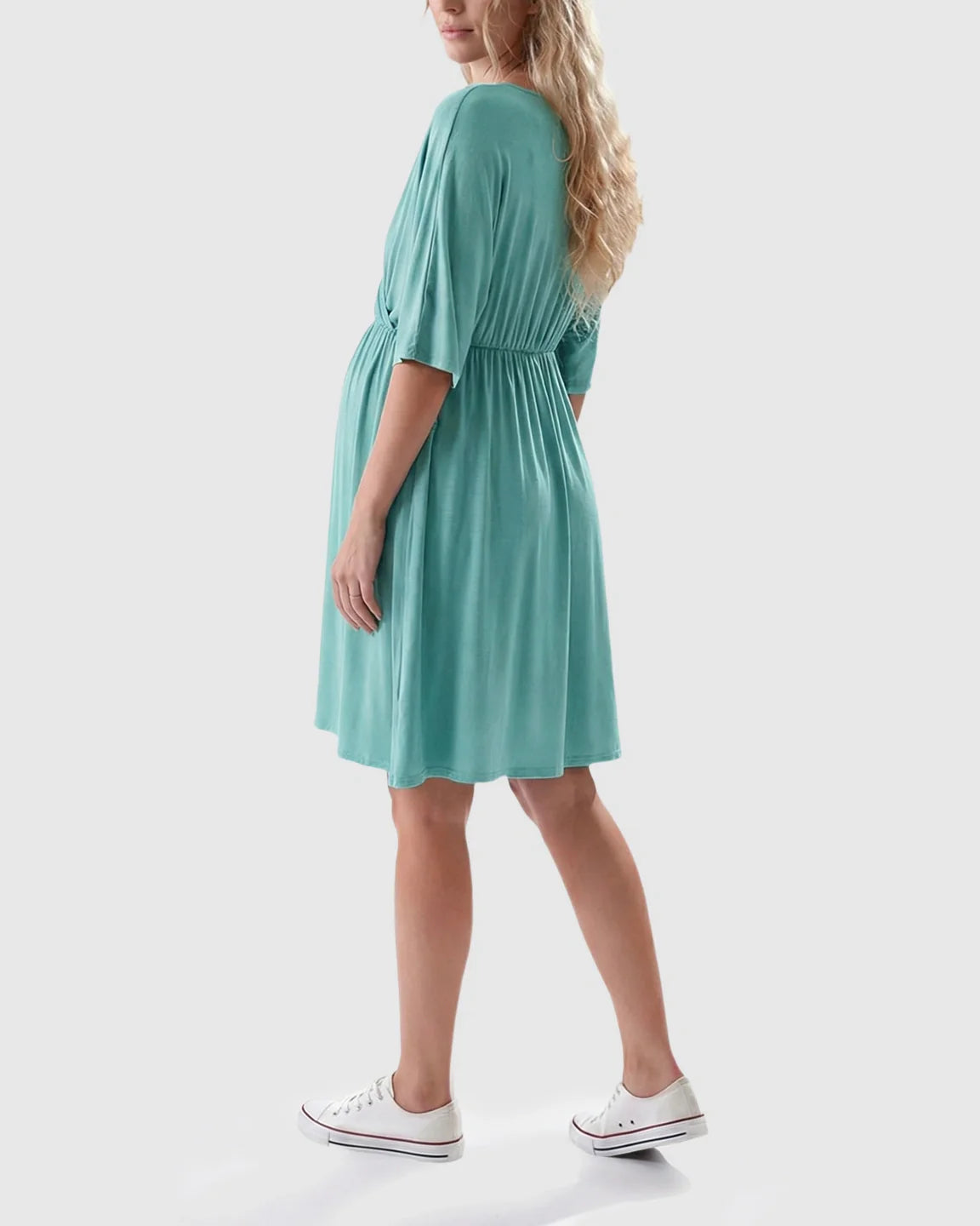 Woman in a teal cross-front maternity midi dress with 3/4 sleeves and a flowy A-line silhouette.