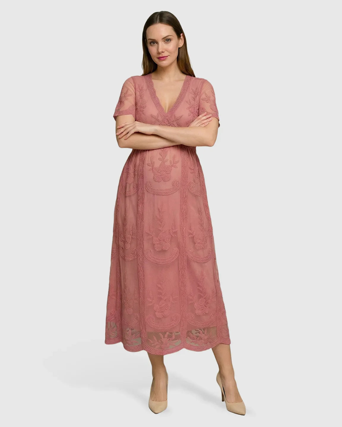 Woman in a pink lace maternity midi dress with V-neck, three-quarter sleeves, and swing skirt.