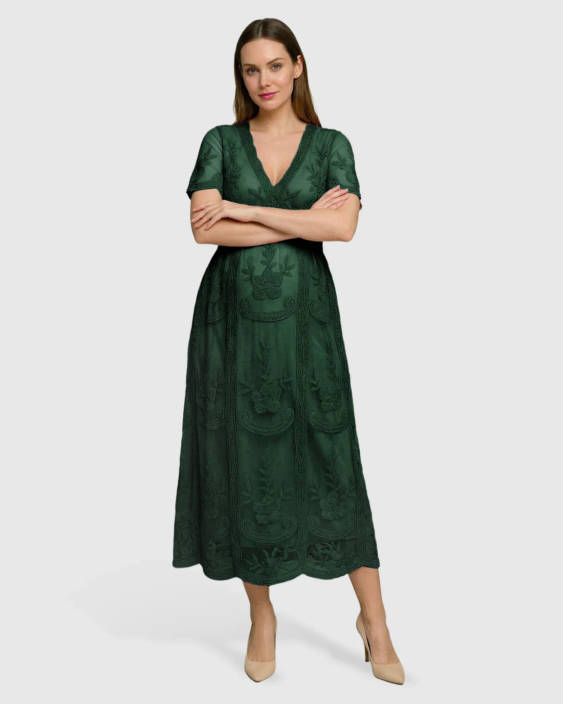 Woman in a dark green lace maternity midi dress with V-neck, three-quarter sleeves, and floral embroidery.