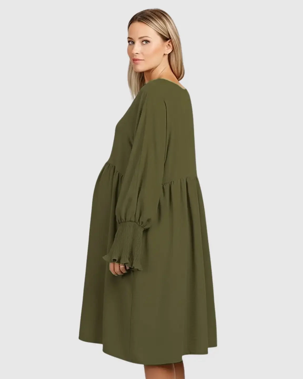 Pregnant woman in a flowy olive green smocked-sleeve casual dress with a round neckline.