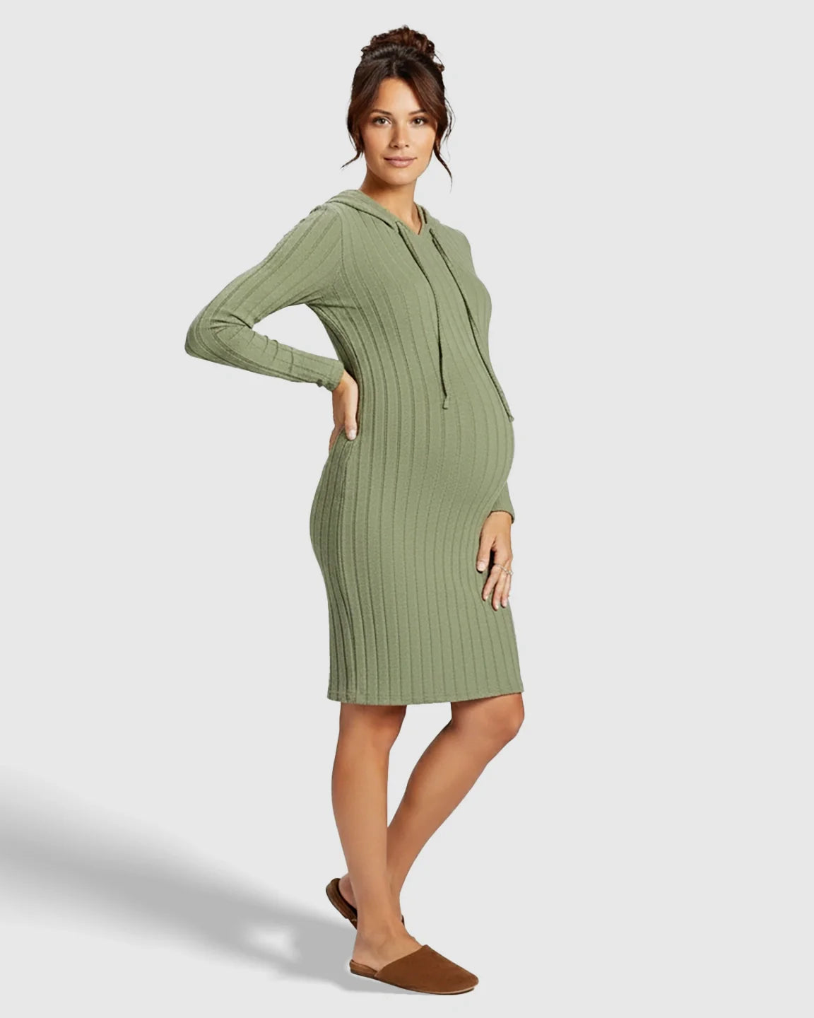 Pregnant woman in a sage green ribbed bodycon hooded maternity midi dress with long sleeves and drawstring.