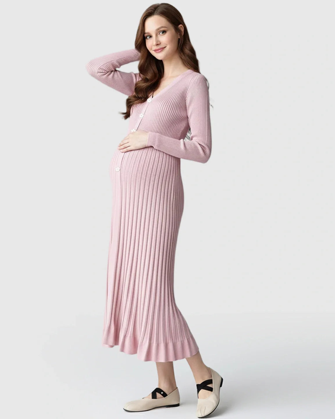 Smiling pregnant woman in a pink ribbed knit maternity midi dress with long sleeves and V-neck.