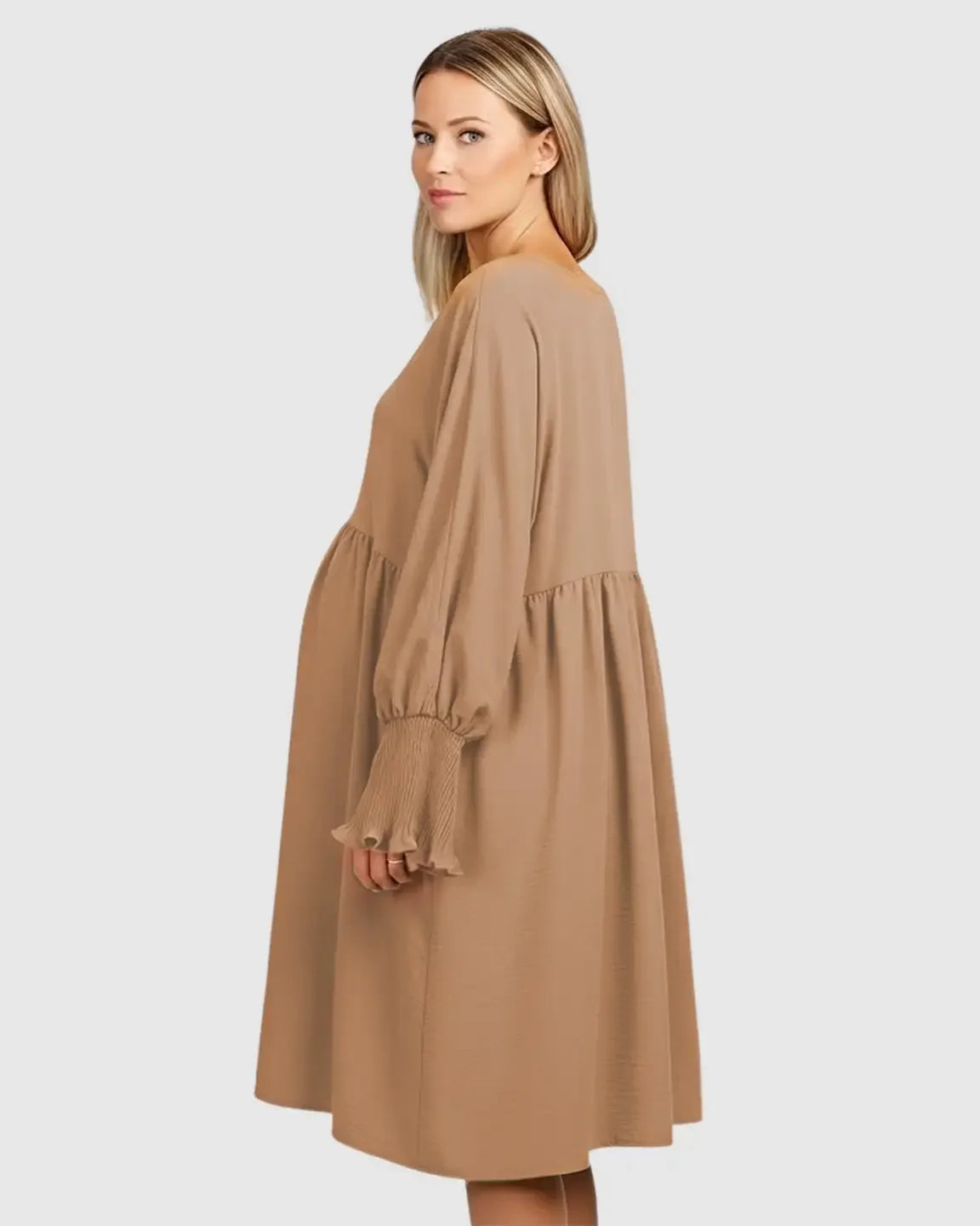Pregnant woman in a tan Flowy Smocked Sleeve Casual Dress with a round neckline and three-quarter sleeves.