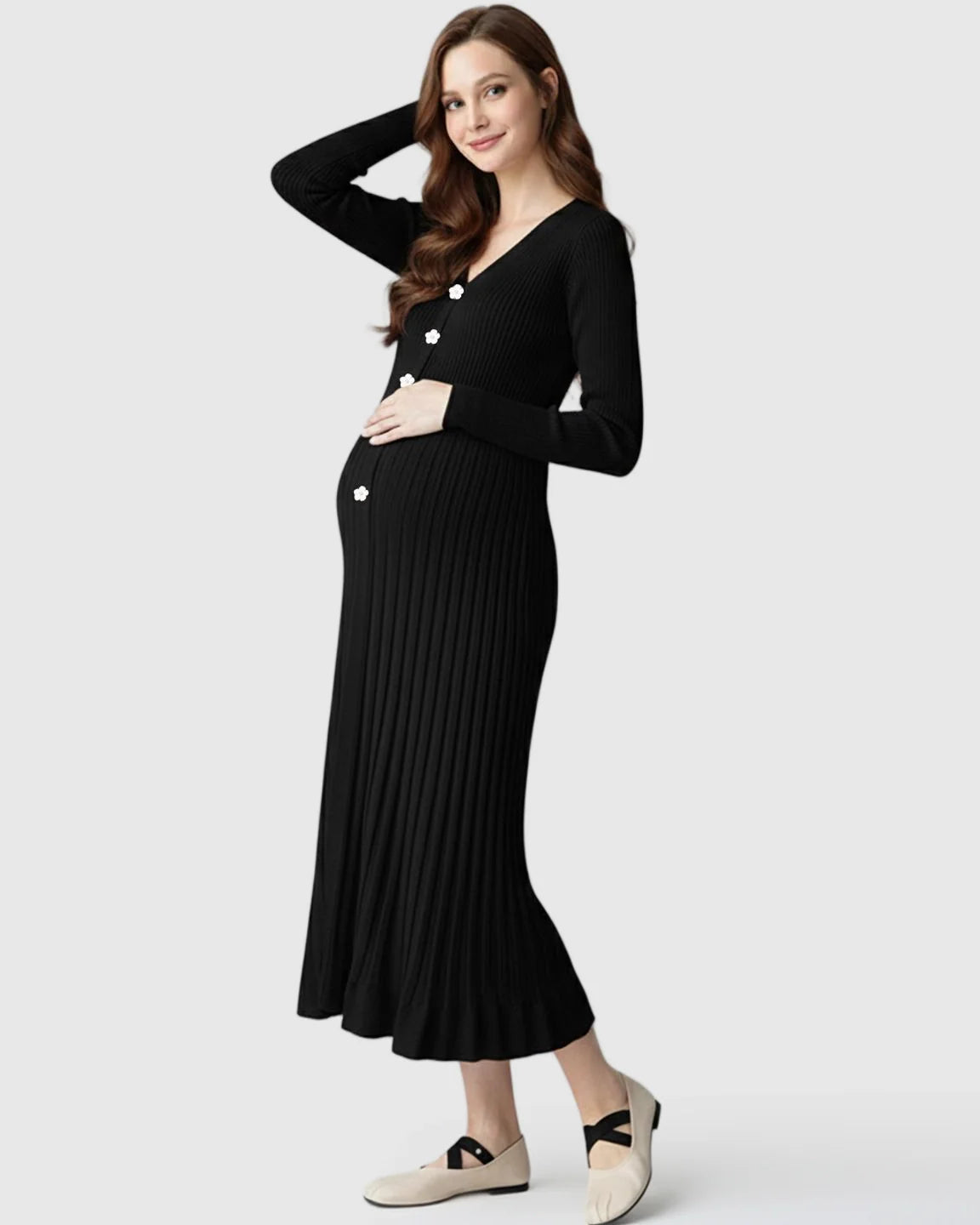 Maternity model in black ribbed knit midi dress with long sleeves, V-neck, and white floral buttons.