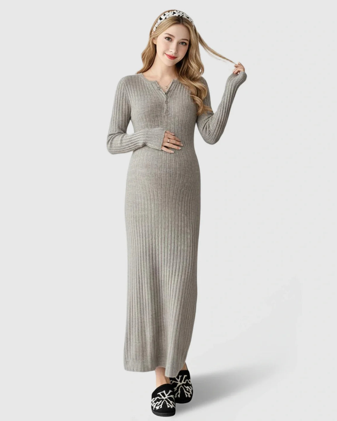 Maternity maxi dress: light gray ribbed knit, long sleeve A-line, model cradling bump.