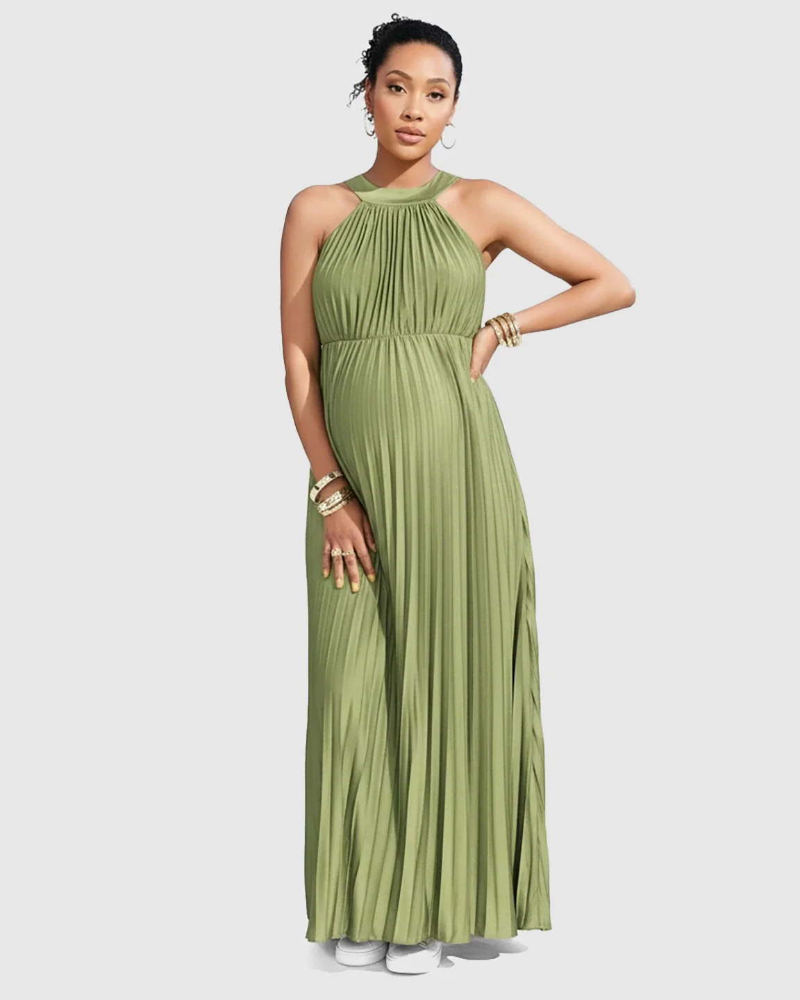 Maternity model in a sage green faux silk halter neck pleated maxi dress, showcasing a flowing silhouette.