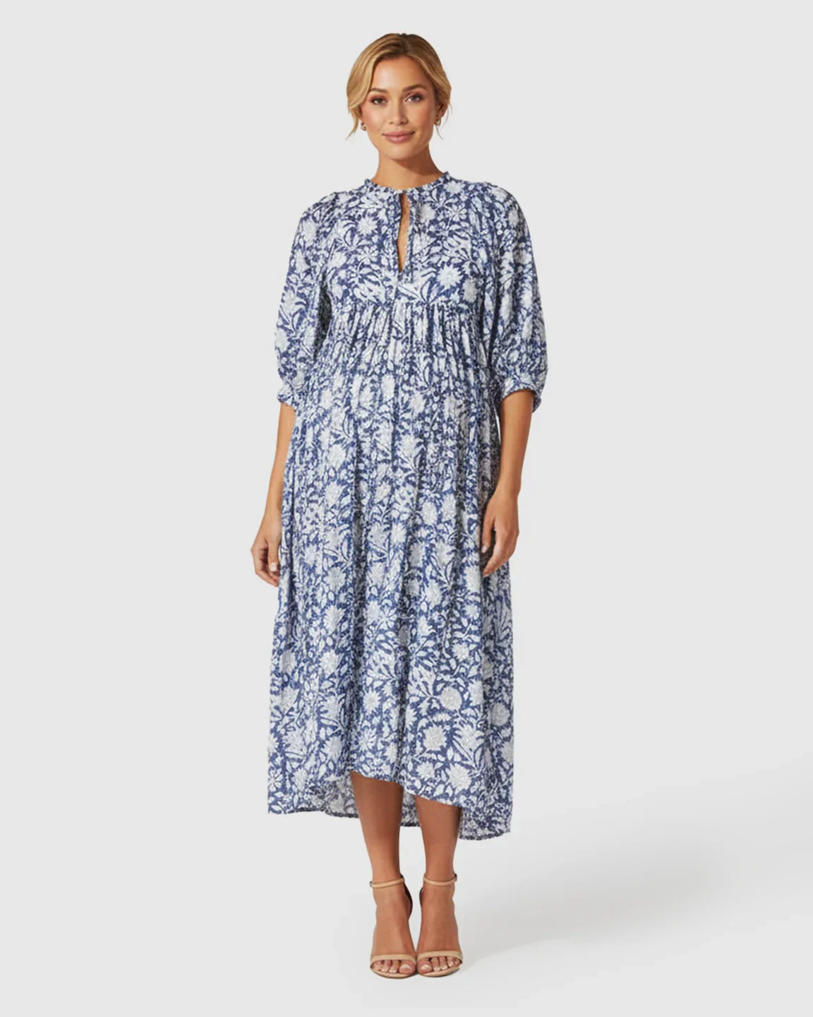 Maternity midi dress in blue and white floral cotton with gathered shoulders, puff sleeves, and a relaxed fit.