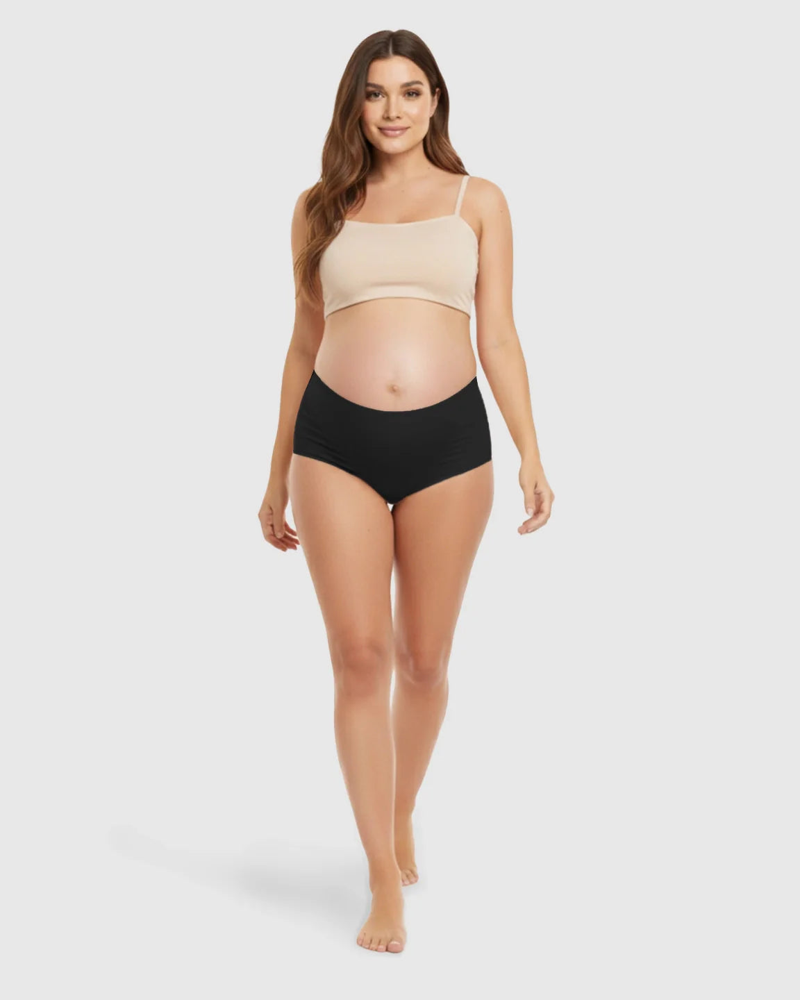 Smiling pregnant woman models black seamless high-waist support maternity underwear.