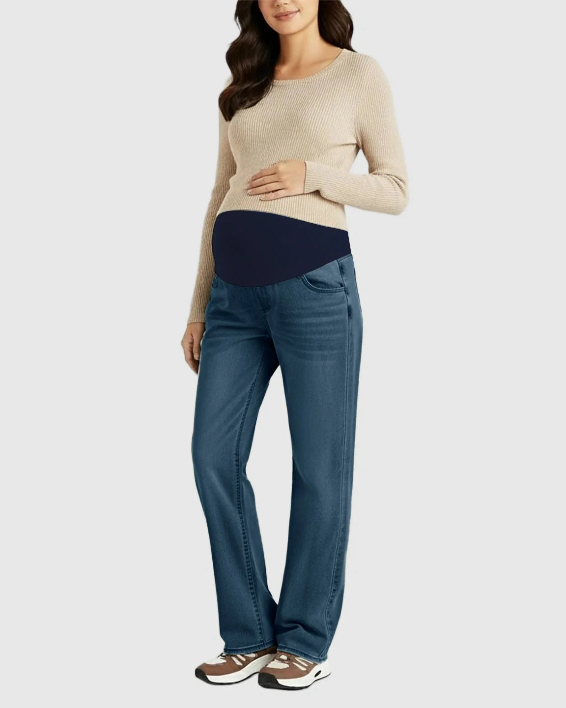 Pregnant woman in blue straight-leg maternity jeans with a navy belly band and a beige sweater.
