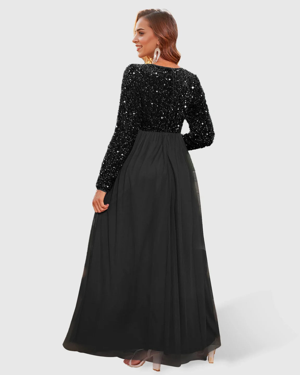 Black sequin long-sleeve empire waist maternity maxi dress with flowing mesh skirt.