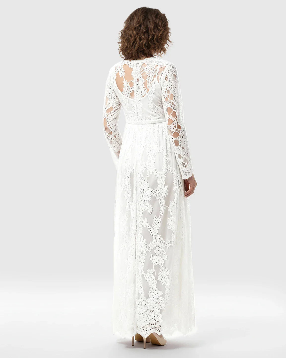 White sheer floral lace empire waist maternity maxi dress with long sleeves and open back detail.