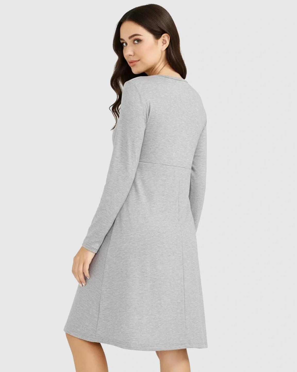 Woman in a grey long-sleeve empire waist nursing dress, designed for comfort and ease.