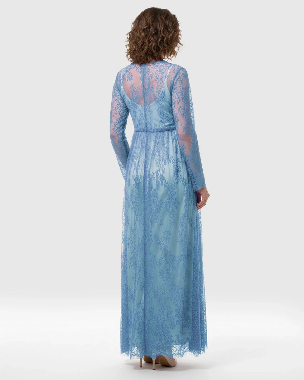 Sheer floral lace empire waist maternity maxi dress in blue, with long sleeves and a flowing skirt.