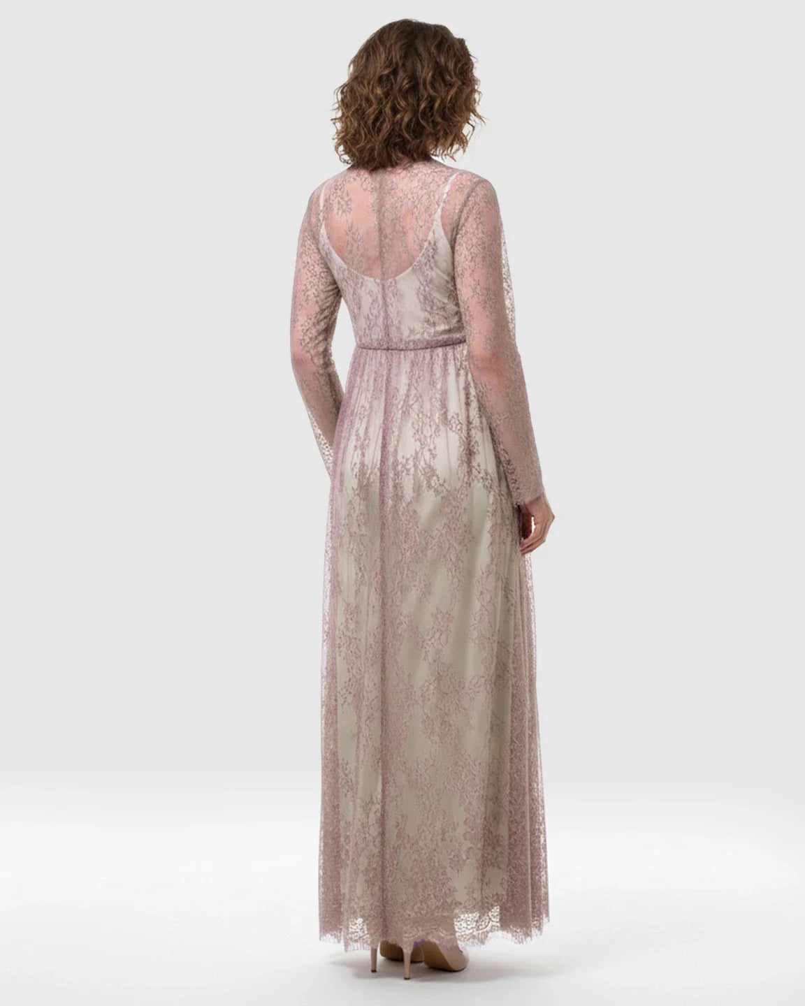 Sheer floral lace empire waist maternity maxi dress in soft mauve, with long sleeves and flowing skirt.