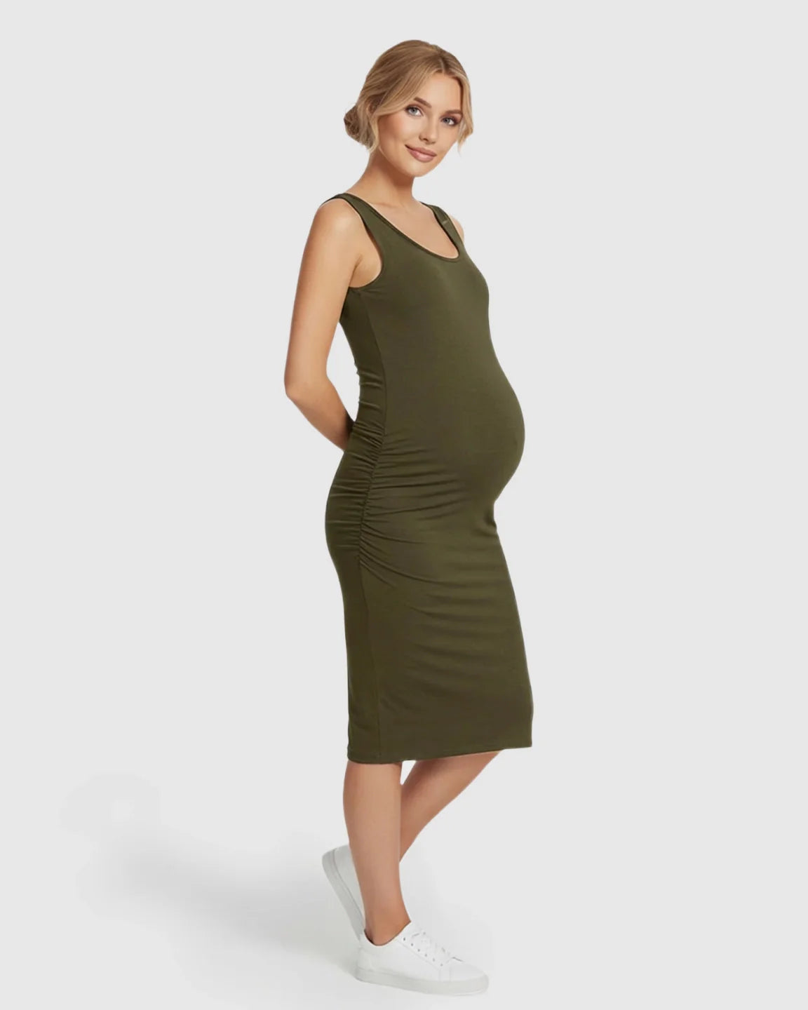 Smiling pregnant woman in a dark olive green sleeveless bodycon maternity dress with side ruching.