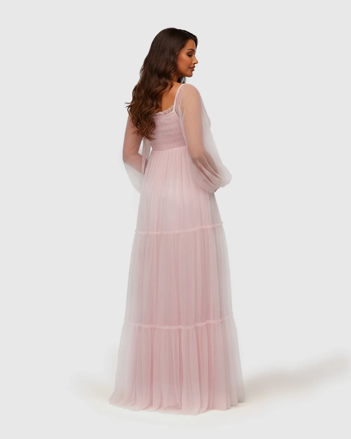 Pink tiered tulle maternity gown with lantern sleeves and smocked bodice.