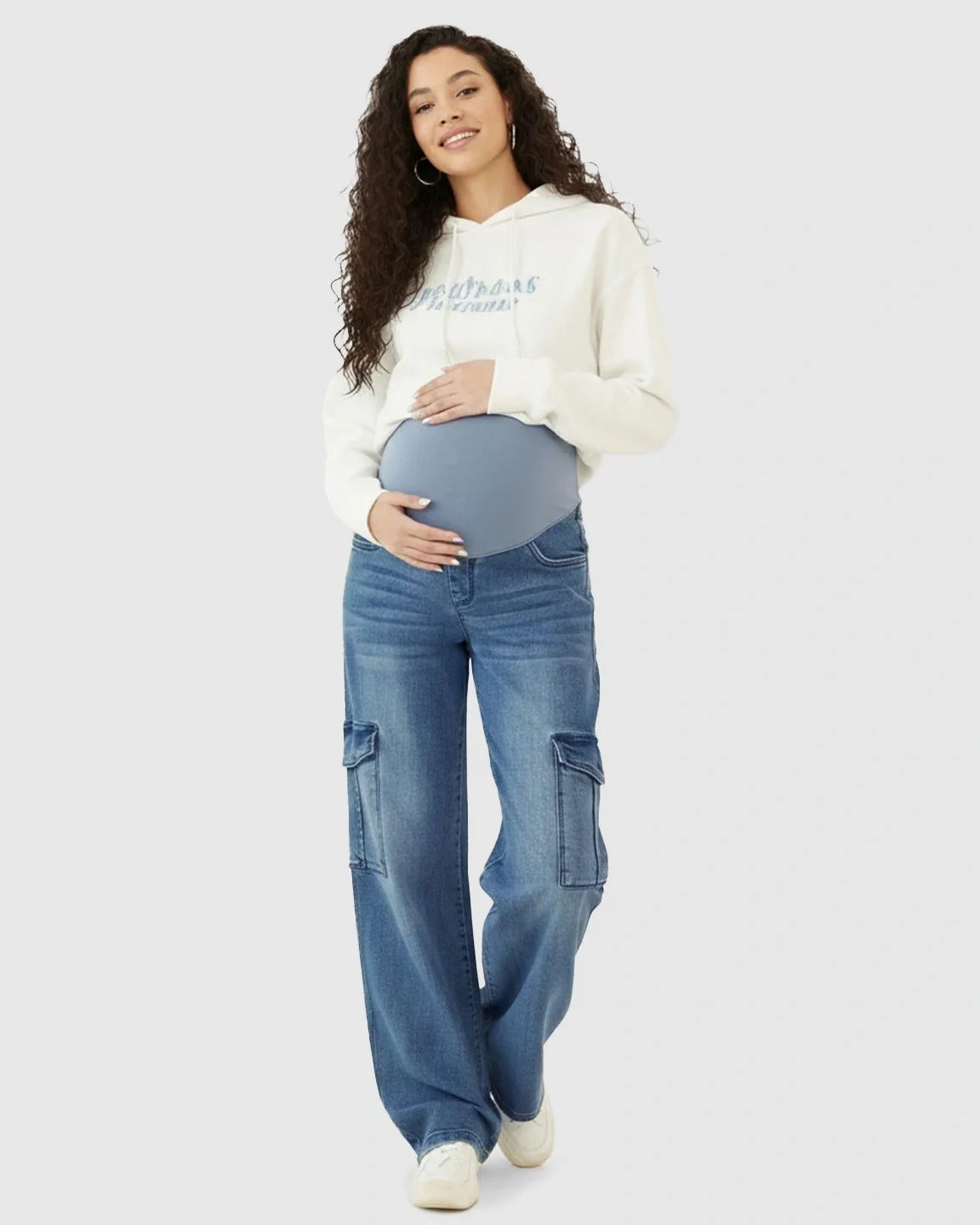 Maternity model in blue wide-leg cargo jeans with an over-bump panel and a white hoodie.
