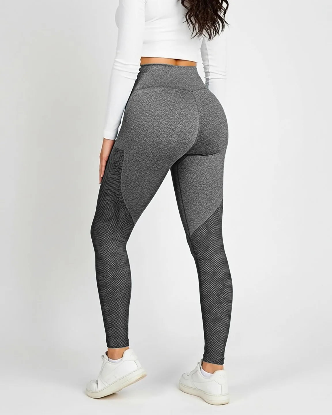 Woman from behind wearing high-waisted, body-hugging gray maternity leggings with mesh panels.