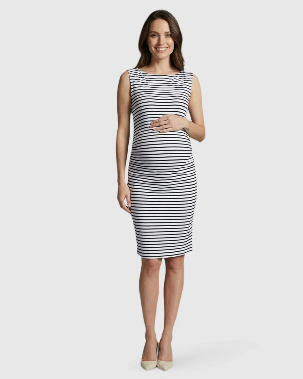 Smiling pregnant woman in a black and white striped sleeveless bodycon maternity midi dress.
