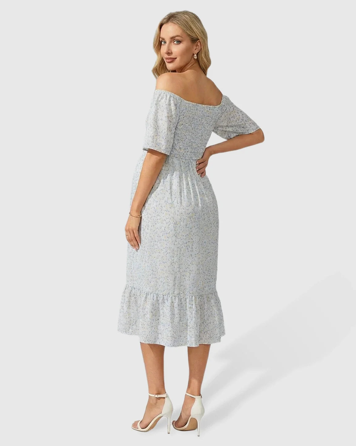 Maternity midi dress with light blue floral print, flutter sleeves, smocked top, and tiered skirt.