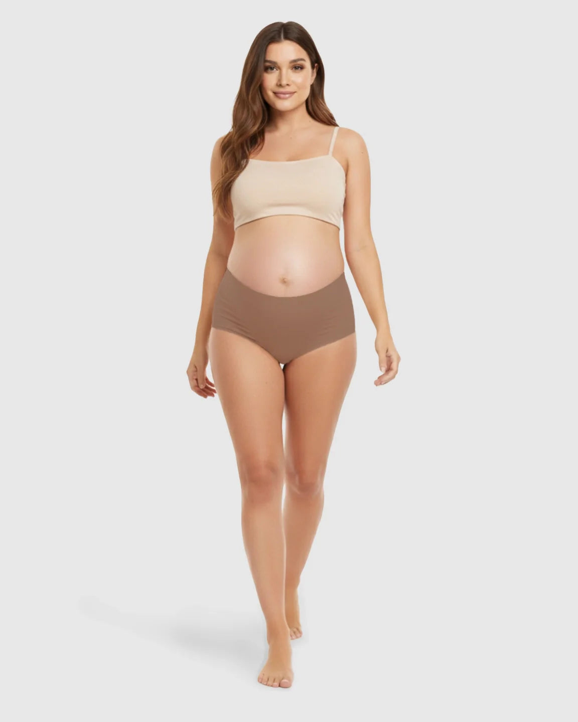 Smiling pregnant woman models seamless high-waist support maternity underwear in brown.