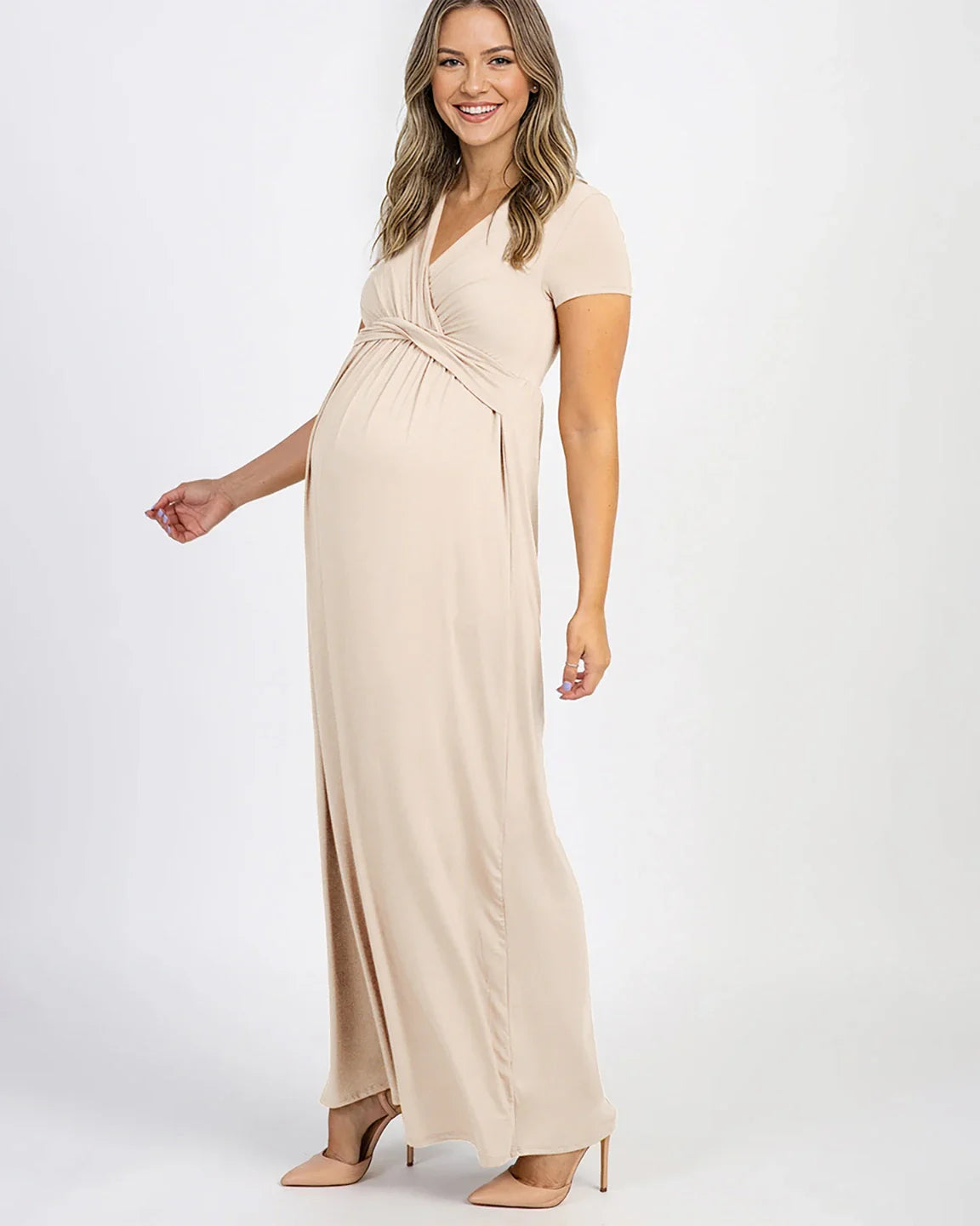 Smiling pregnant woman in a beige Twist Front Draped Maternity Nursing Maxi Dress.