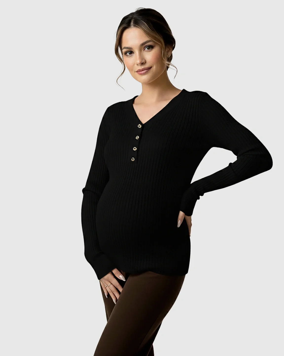 Pregnant woman in a black ribbed V-neck maternity nursing sweater with gold buttons.