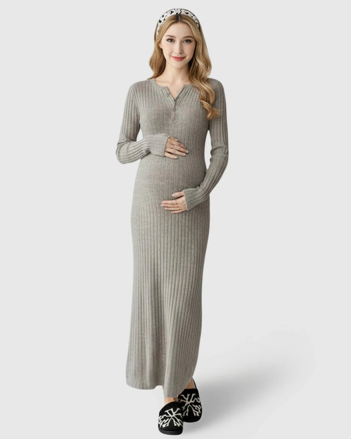 Smiling pregnant woman in a gray ribbed knit A-line long sleeve maternity maxi dress.
