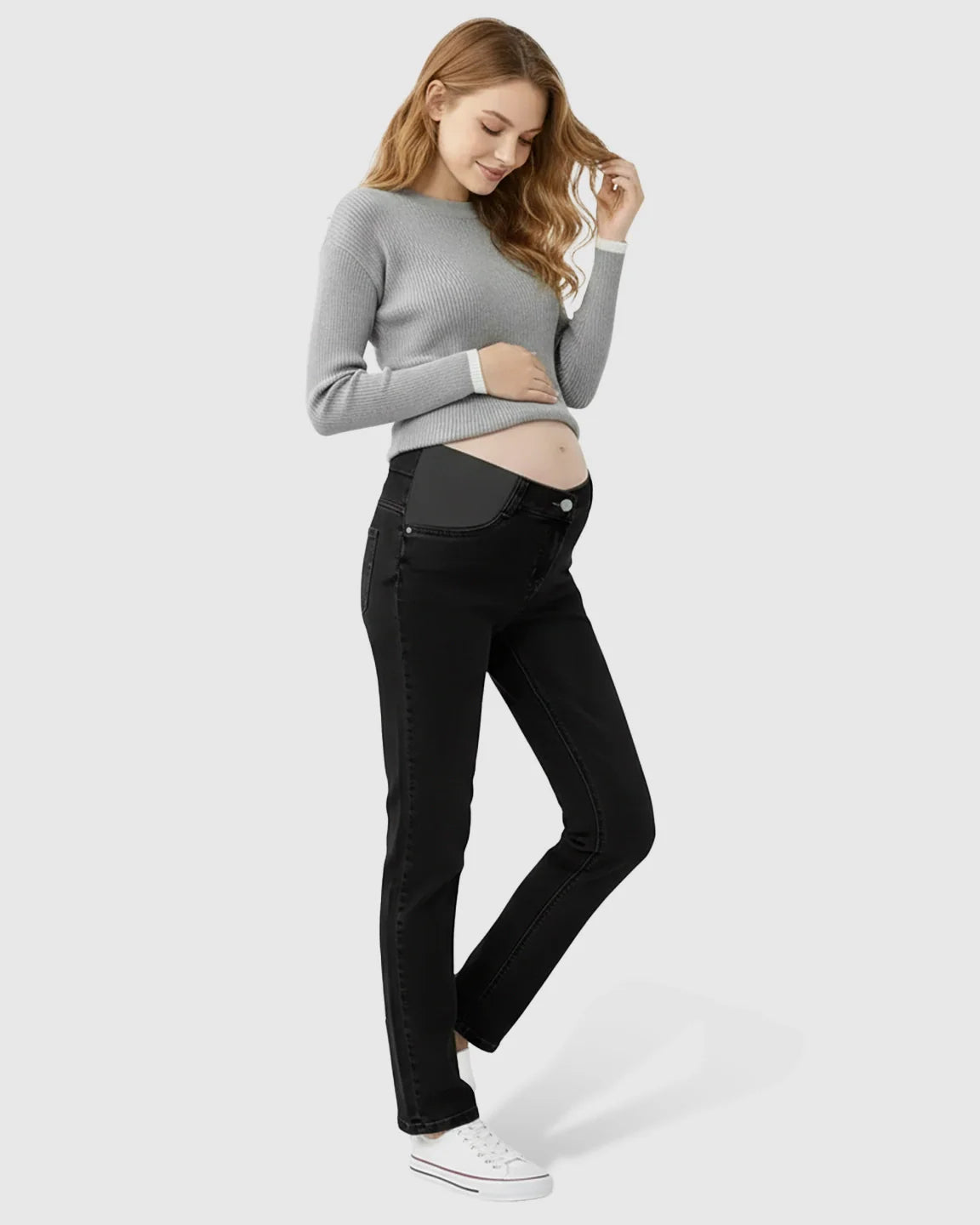 Pregnant woman in black straight-leg maternity jeans with side panels and a grey sweater.