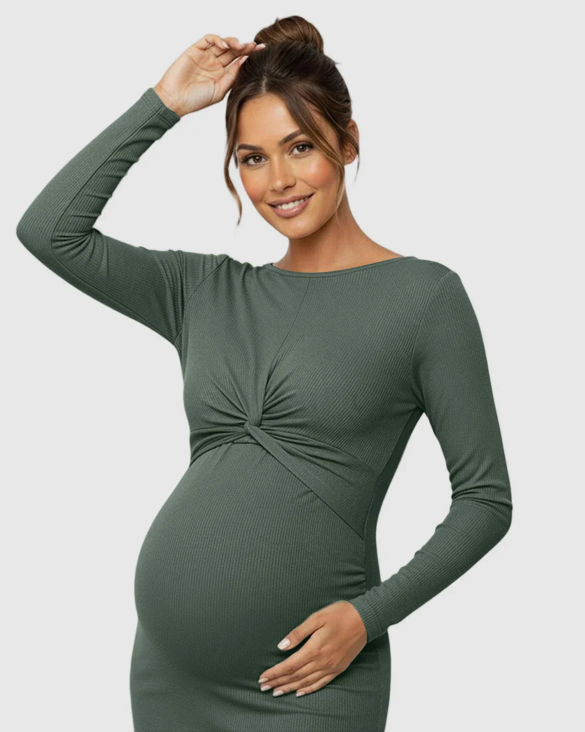 Smiling pregnant woman in a long-sleeve olive green ribbed bodycon maternity dress with a twist-front detail.